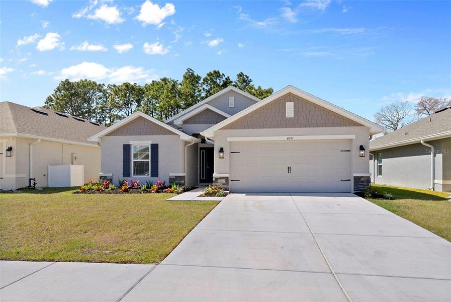 Front exterior of a new home in Pine Bluff, Spring Hill, FL, highlighting curb appeal (Image 22).
