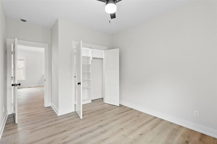 Unfurnished bedroom with light wood-type flooring and a ceiling fan