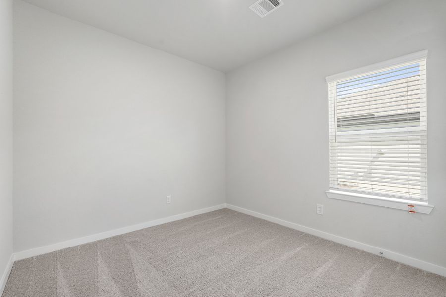 A room with a window and a carpet. A room with a window and a carpet.