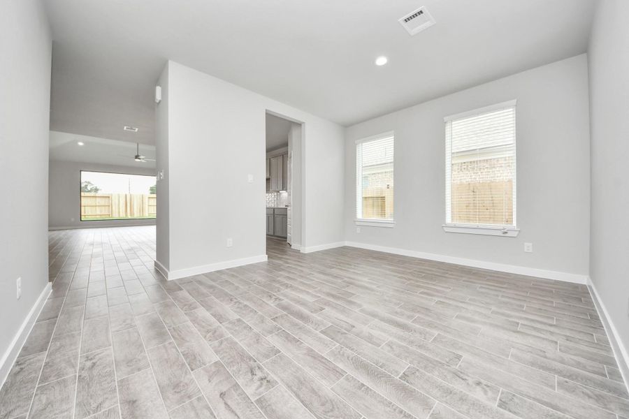 Make memories gathered around the table with your family and friends! This spacious dining room features elegant flooring, custom paint, and adjacent to family room and kitchen for open concept feel. Sample photo of completed home with similar floor plan. Actual colors and selections may vary.