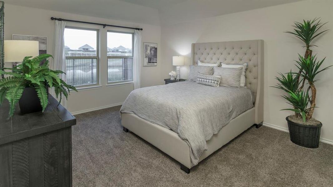 Bedroom featuring two windows with privacy blinds, neutral carpeting, and light-toned walls Bedroom featuring two windows with privacy blinds, neutral carpeting, and light-toned walls