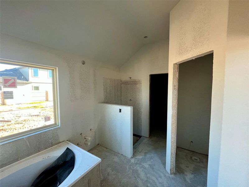Full bathroom featuring a walk in shower, a garden tub, and lofted ceiling Full bathroom featuring a walk in shower, a garden tub, and lofted ceiling