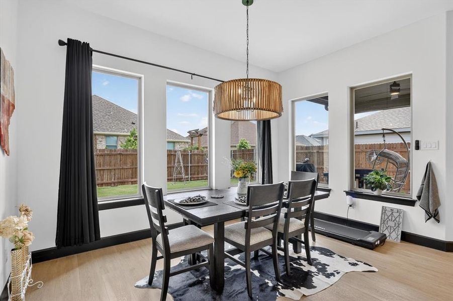 Dining area with light wood-finish flooring