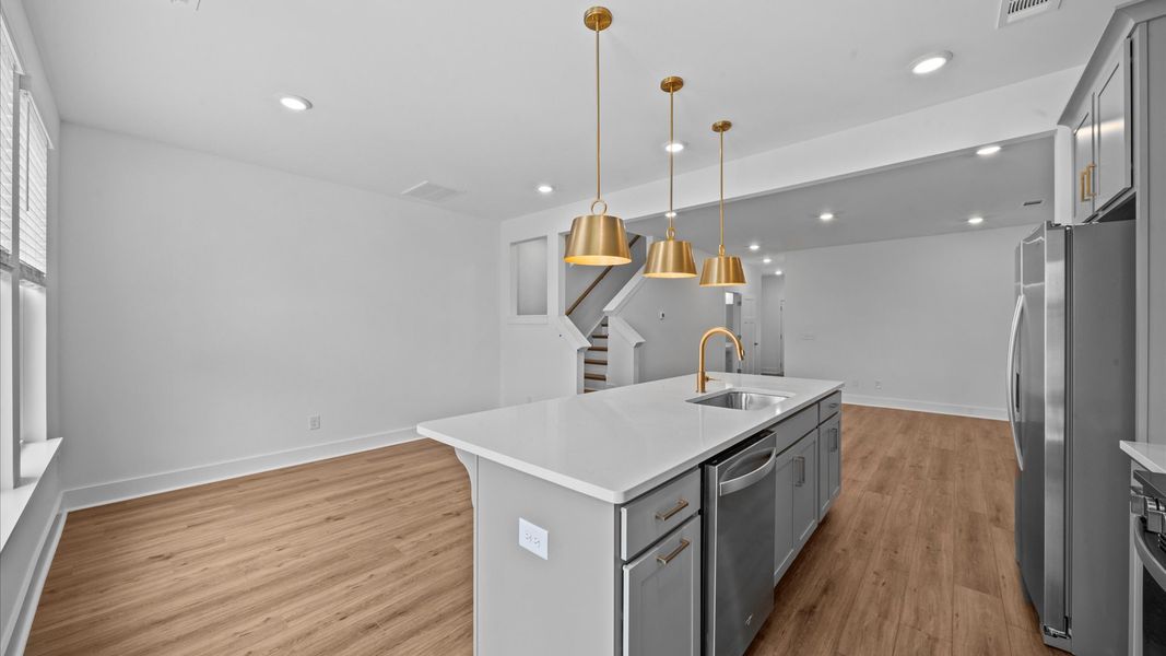 9-foot kitchen island with white quartz countertops in two story townhome at Ransdell Pointe by DRB Homes in Spartanburg, SC