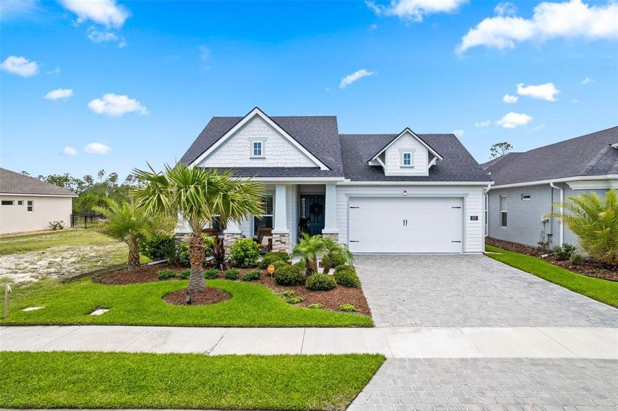 Front exterior of a new home in Mosaic, Daytona Beach, FL, highlighting curb appeal (Image 2). Front exterior of a new home in Mosaic, Daytona Beach, FL, highlighting curb appeal (Image 2).