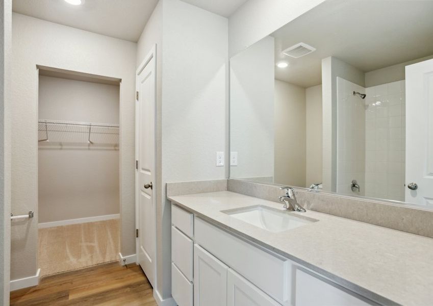 The master bathroom has a large vanity and a tub/shower combo.