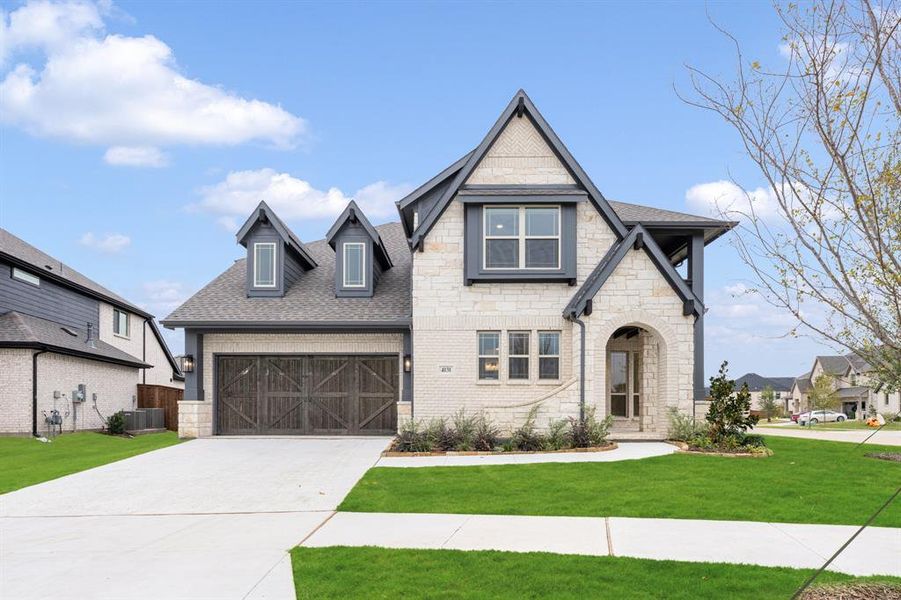 Front exterior of a new home in Windsong Ranch Classic 61, Prosper, TX, highlighting curb appeal (Image 1). Front exterior of a new home in Windsong Ranch Classic 61, Prosper, TX, highlighting curb appeal (Image 1).