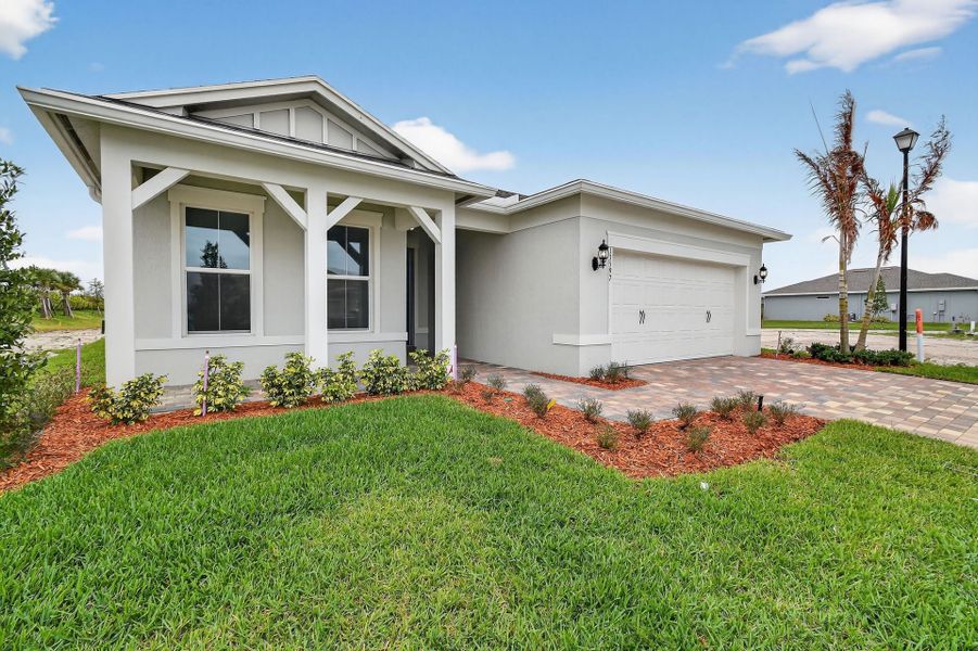 Front exterior of a new home in Del Webb Tradition, Port St. Lucie, FL, highlighting curb appeal (Image 32).