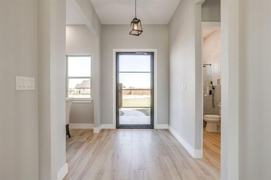 Entryway featuring light wood-type flooring and baseboards