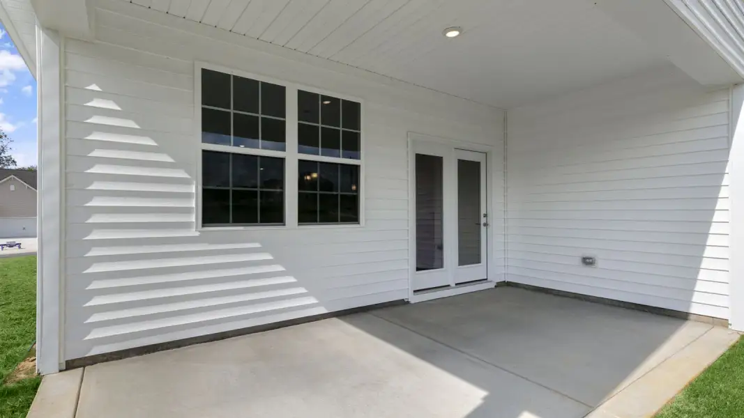 Exterior details and patio area of a home in The Villas at Galvins Ridge, Sanford (Image 18).