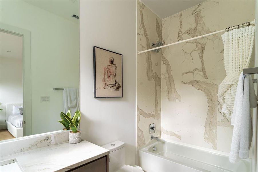 Full bathroom with vanity, toilet, and shower / bathtub combination with curtain Full bathroom with vanity, toilet, and shower / bathtub combination with curtain