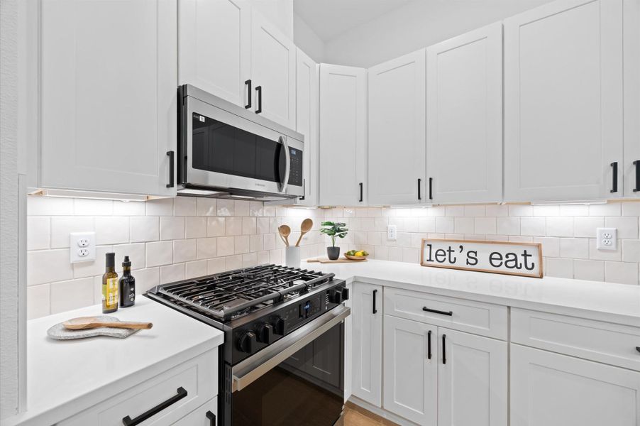 This attractive Kitchen is full of beautiful details. Quartz Countertops, Stainless steel Sink, Stainless Steel Appliances, Recessed Lighting, Undercabinet Lighting, Elegant Cabinetry with Soft Close Drawers and Doors