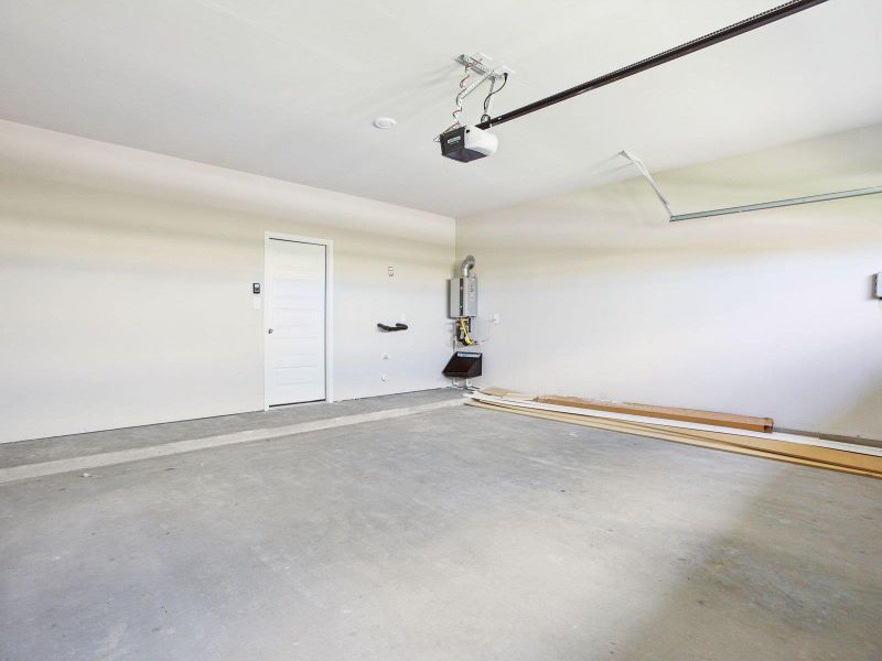 Garage with a garage door opener and water heater Garage with a garage door opener and water heater