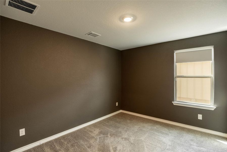 Unfurnished room with baseboards and light carpet Unfurnished room with baseboards and light carpet