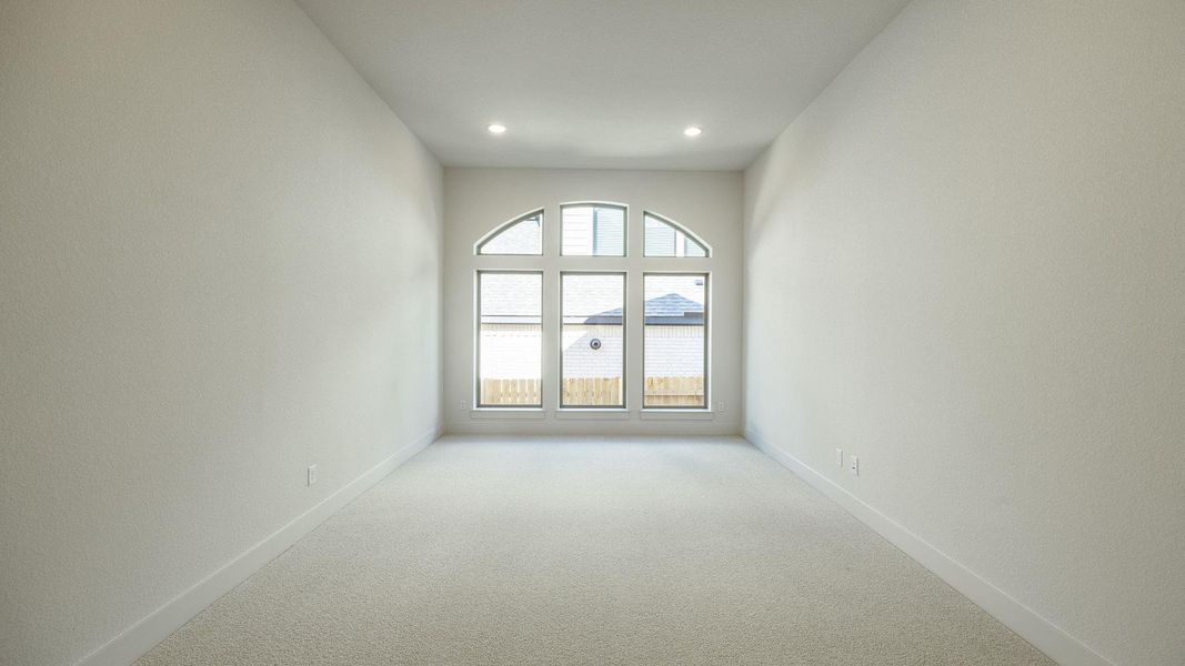 Empty room featuring carpet floors and recessed lighting