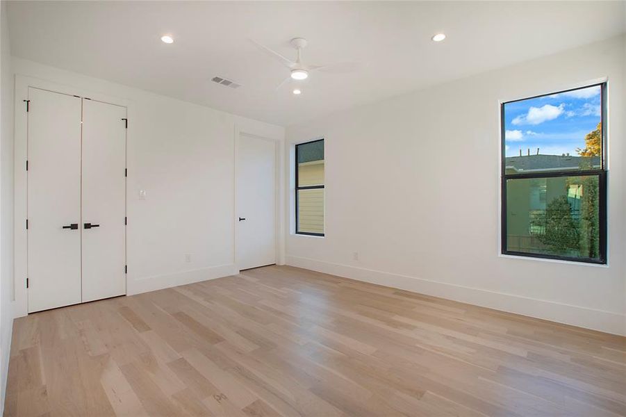 Unfurnished bedroom with light hardwood / wood-style floors and ceiling fan