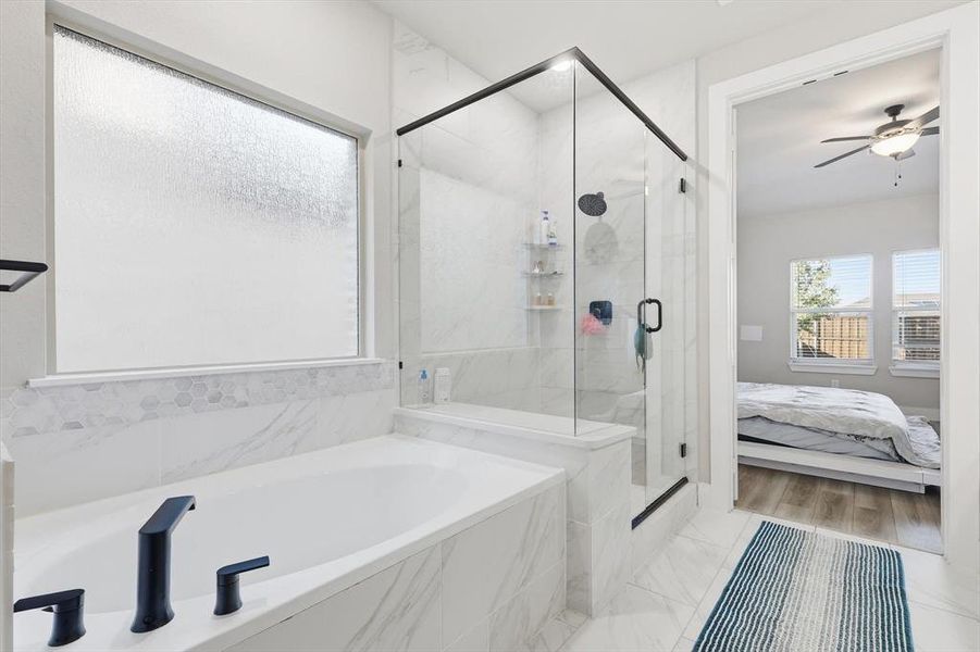 Full bath featuring a bath, a marble finish shower, a ceiling fan, and connected bathroom