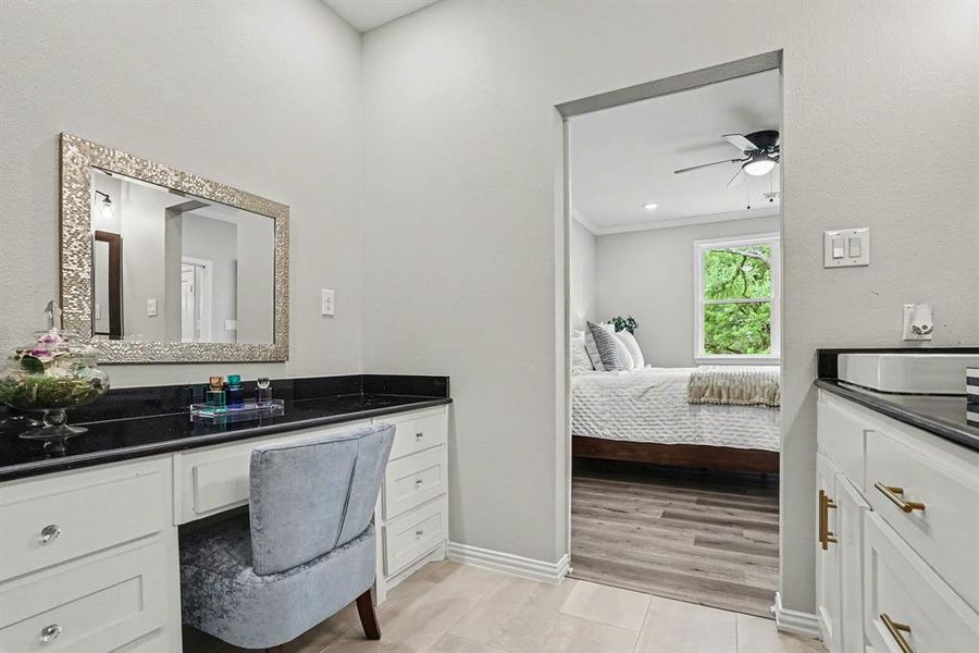 Full bathroom featuring vanity, ensuite bath, light tile patterned flooring, ornamental molding, and a ceiling fan