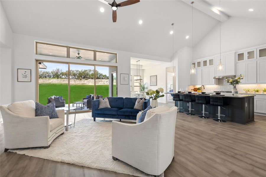 Living room with ceiling fan, high vaulted ceiling, wood finished floors, beamed ceiling, and recessed lighting