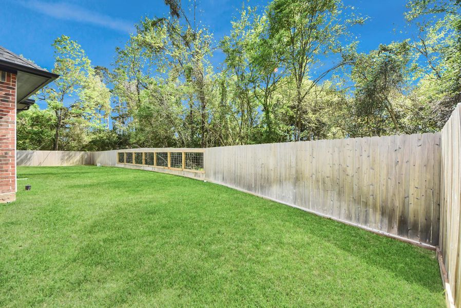Another view of fully fenced yard offering privacy and outdoor enjoyment.