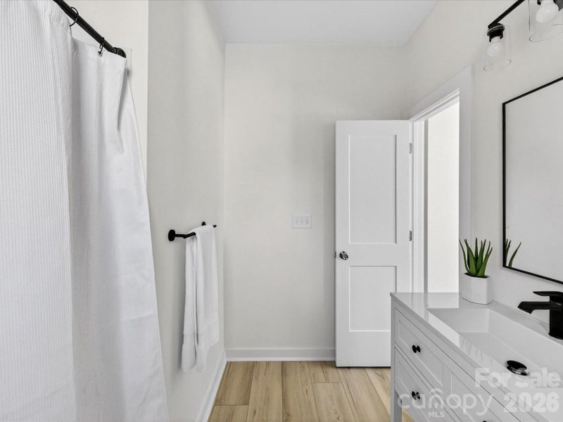 Primary suite bathroom features sleek modern finishes, a spacious layout, designed for everyday comfort and style.