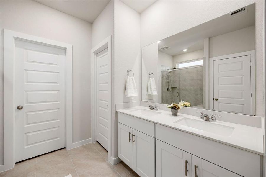 This primary bathroom is definitely move-in ready! Featuring an oversized spa like walk-in shower with tile surround, sleek white cabinets with light countertops, spacious walk-in closet with shelving, high ceilings, neutral paint, and modern finishes.