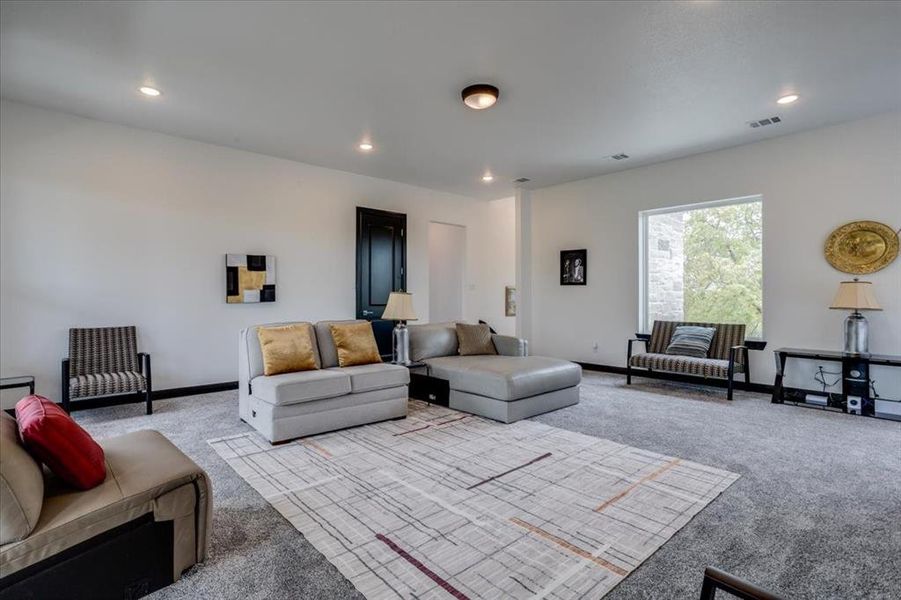 Carpeted living room featuring recessed lighting