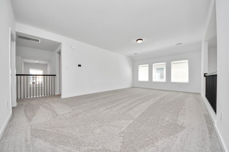 Come upstairs and enjoy a day of leisure in this fabulous game room! This is the perfect hangout spot or adult game room! Features plush carpet, high ceilings, custom paint and windows for plenty of natural light.