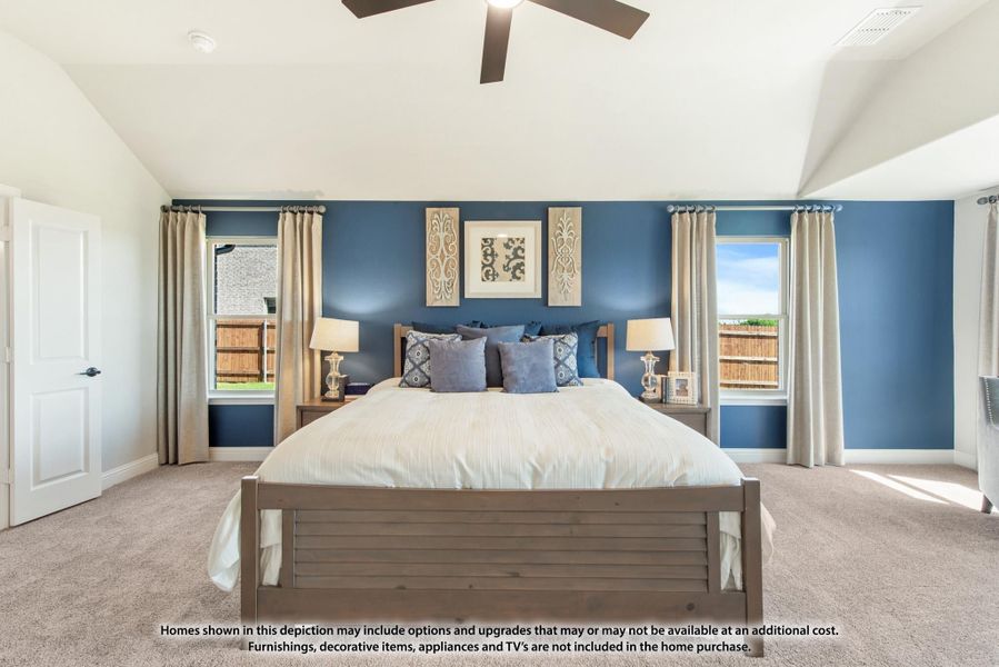 Bedroom with blue accent wall, vaulted ceiling, ceiling fan, and king-size bed with two windows Bedroom with blue accent wall, vaulted ceiling, ceiling fan, and king-size bed with two windows
