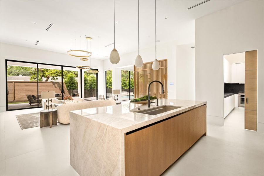 Centrally located kitchen offering clear sightlines to the living area, outdoor spaces, and adjoining scullery.