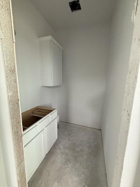 A well-proportioned utility room with a compact layout and ready-to-finish cabinetry.