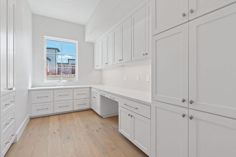 2nd home office featuring light wood finished floors and built in desk 2nd home office featuring light wood finished floors and built in desk