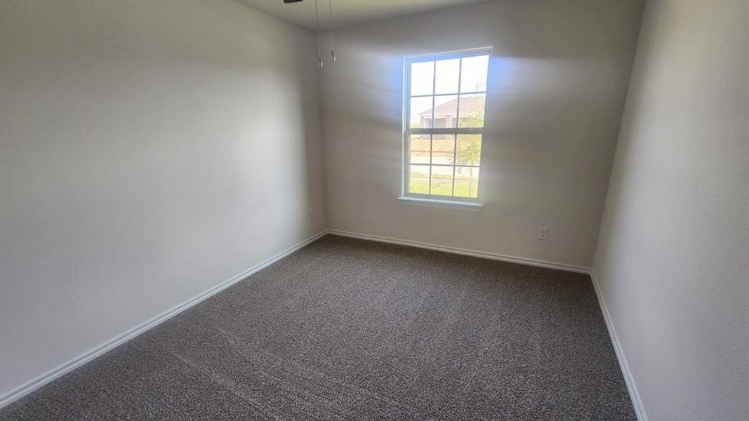 Neutral-toned walls complement the gray carpeting