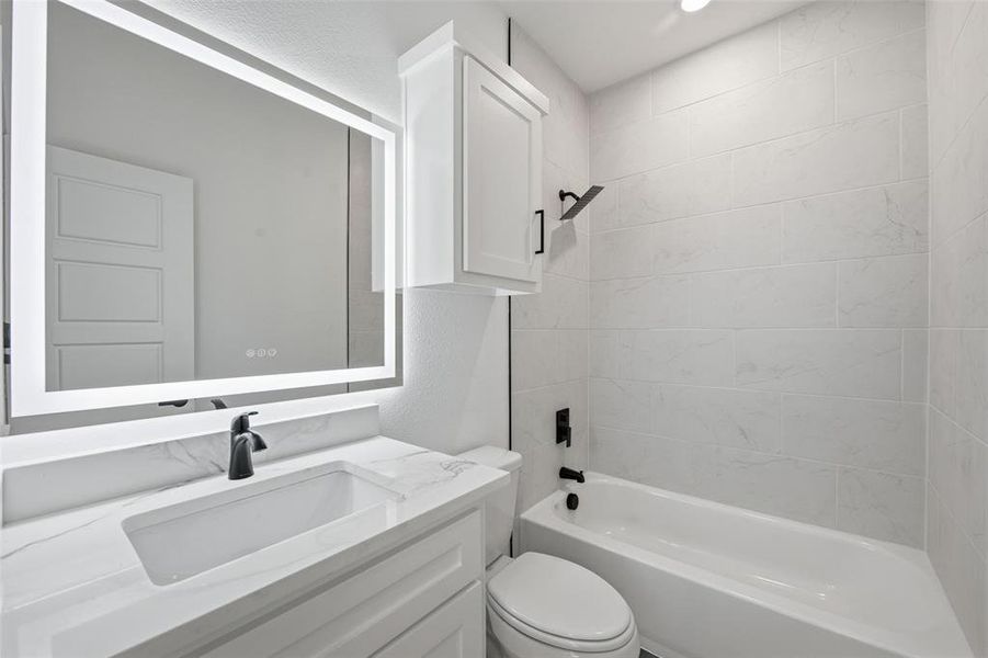 Bathroom featuring shower / washtub combination and vanity