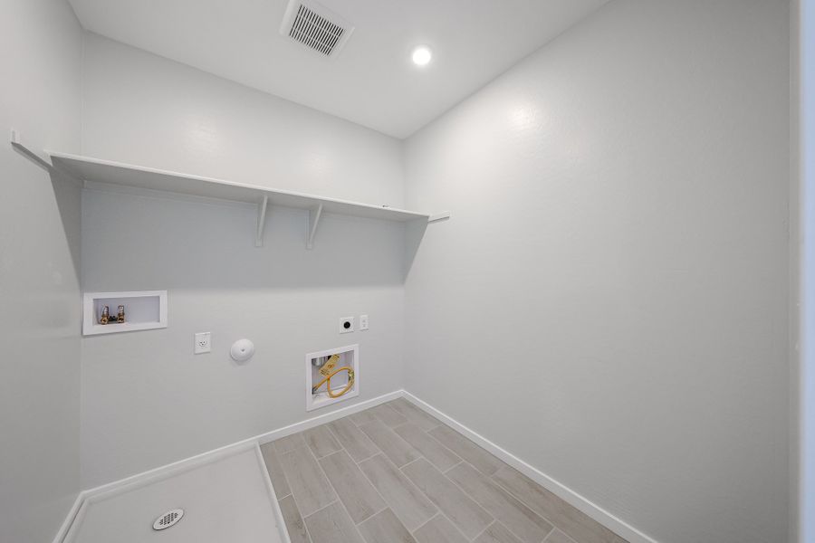 A white tiled hallway. A white tiled hallway.