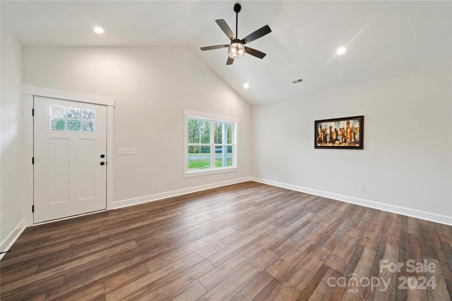 Den without furniture shows how spacious & how much light. Notice cathedral ceiling.