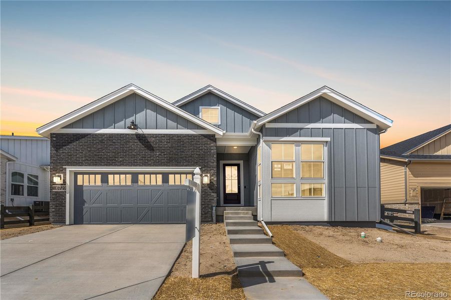 Front exterior of a new home in Reserve at The Canyons, Castle Pines, CO, highlighting curb appeal (Image 2).