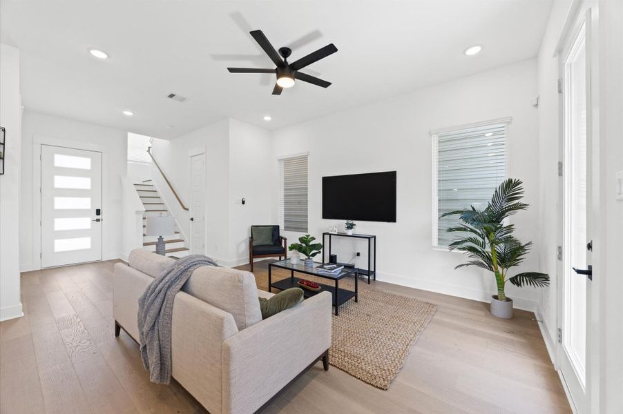 An open-concept living room seamlessly blends with adjacent spaces, creating a spacious and inviting atmosphere. Large windows allow natural light to flood in. An open-concept living room seamlessly blends with adjacent spaces, creating a spacious and inviting atmosphere. Large windows allow natural light to flood in.