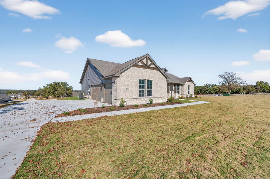 Front exterior of a new home in Oak Grove Addition, Springtown, TX, highlighting curb appeal (Image 25).