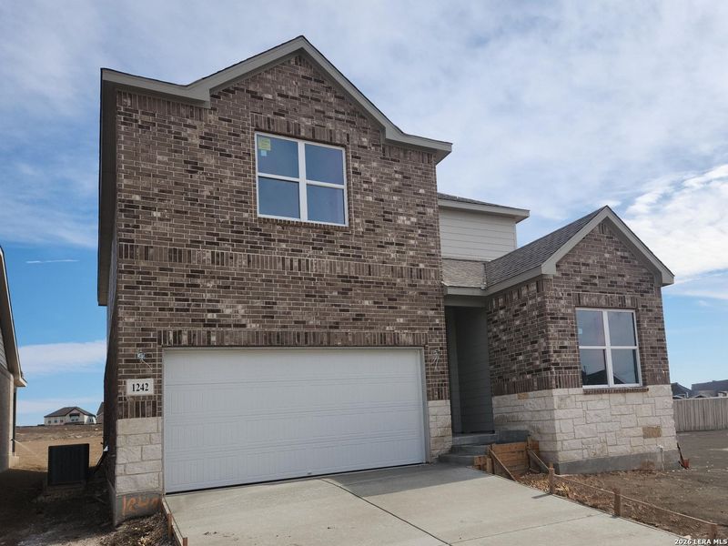 Front exterior of a new home in Arcadia Ridge, San Antonio, TX, highlighting curb appeal (Image 2). Front exterior of a new home in Arcadia Ridge, San Antonio, TX, highlighting curb appeal (Image 2).