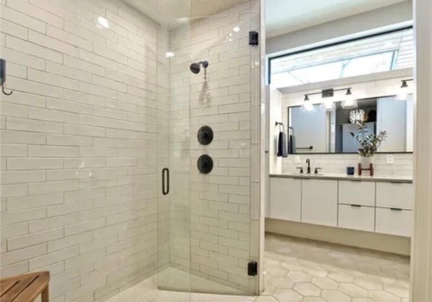 Full bath with double vanity, a stall shower, decorative backsplash, and light tile patterned flooring Full bath with double vanity, a stall shower, decorative backsplash, and light tile patterned flooring