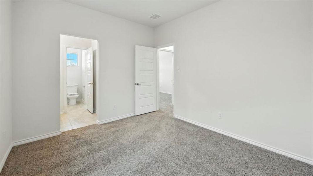 Unfurnished bedroom featuring carpet flooring and ensuite bathroom Unfurnished bedroom featuring carpet flooring and ensuite bathroom