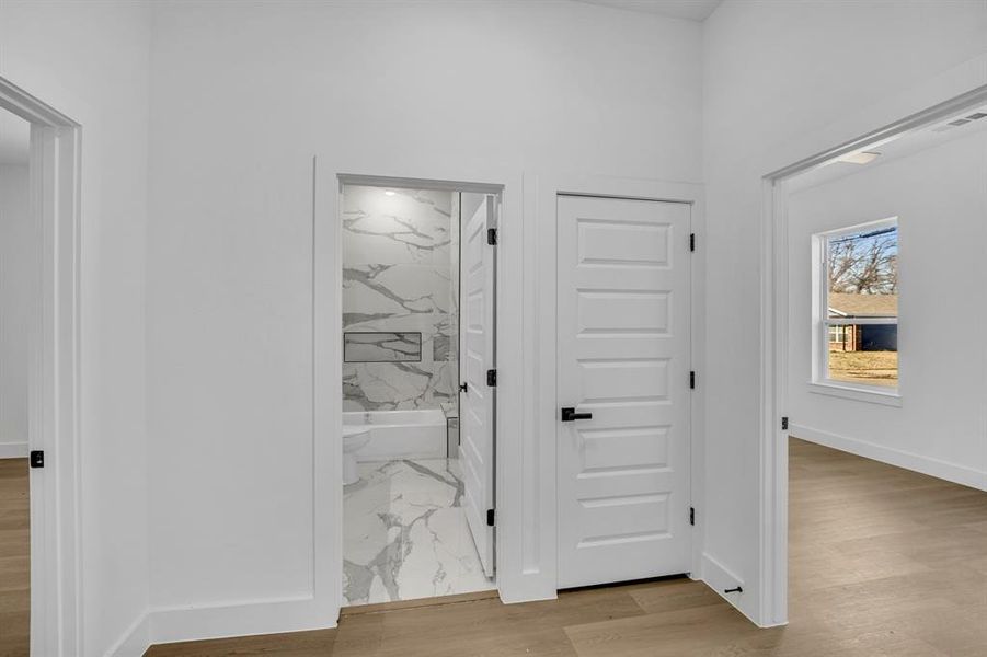 Hall with light hardwood / wood-style floors