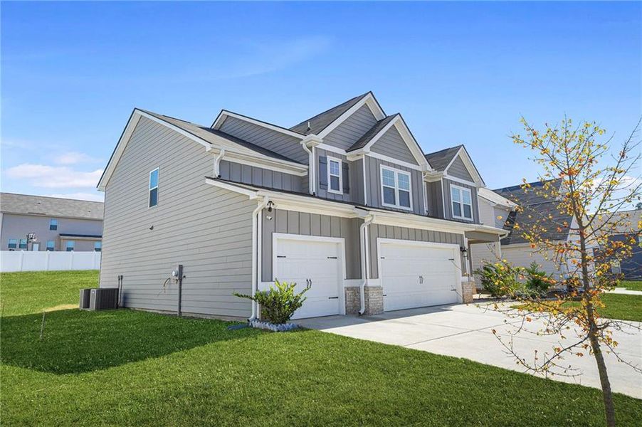 Front exterior of a new home in Berkeley Lakes, Locust Grove, GA, highlighting curb appeal (Image 1).