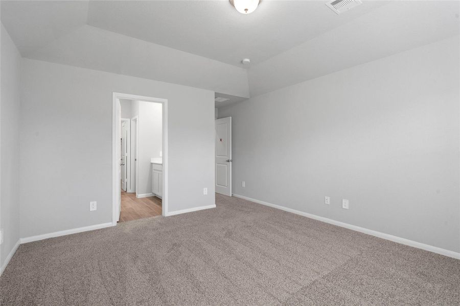 The private primary suite efficiently connects the sleeping area with the dedicated bathroom and generous closet.