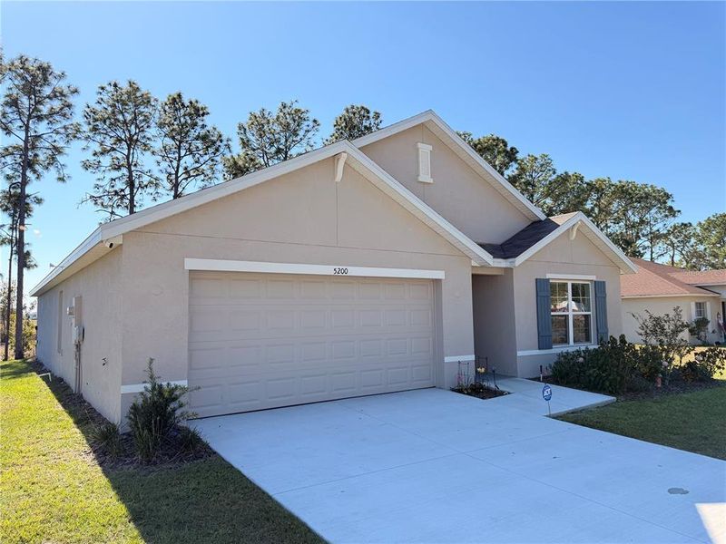 Front exterior of a new home in Marion County Spot Lots, Ocala, FL, highlighting curb appeal (Image 17).