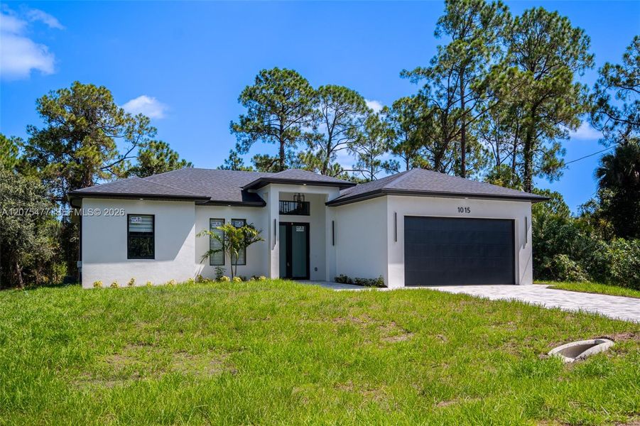 Front exterior of a new home in , Lehigh Acres, FL, highlighting curb appeal (Image 32). Front exterior of a new home in , Lehigh Acres, FL, highlighting curb appeal (Image 32).