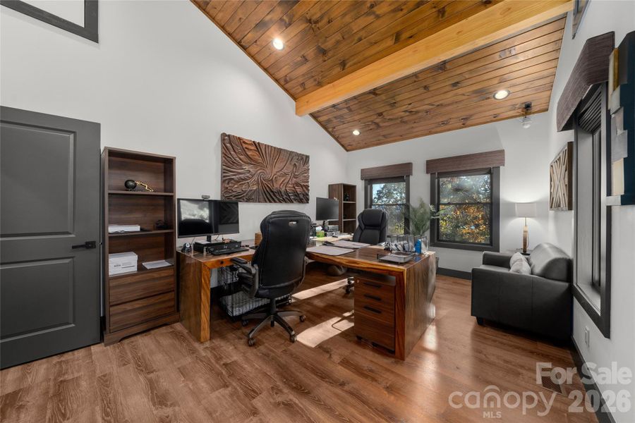 Huge front facing flex room used as a double office with custom closet and access to the partially  finished, full height attic.