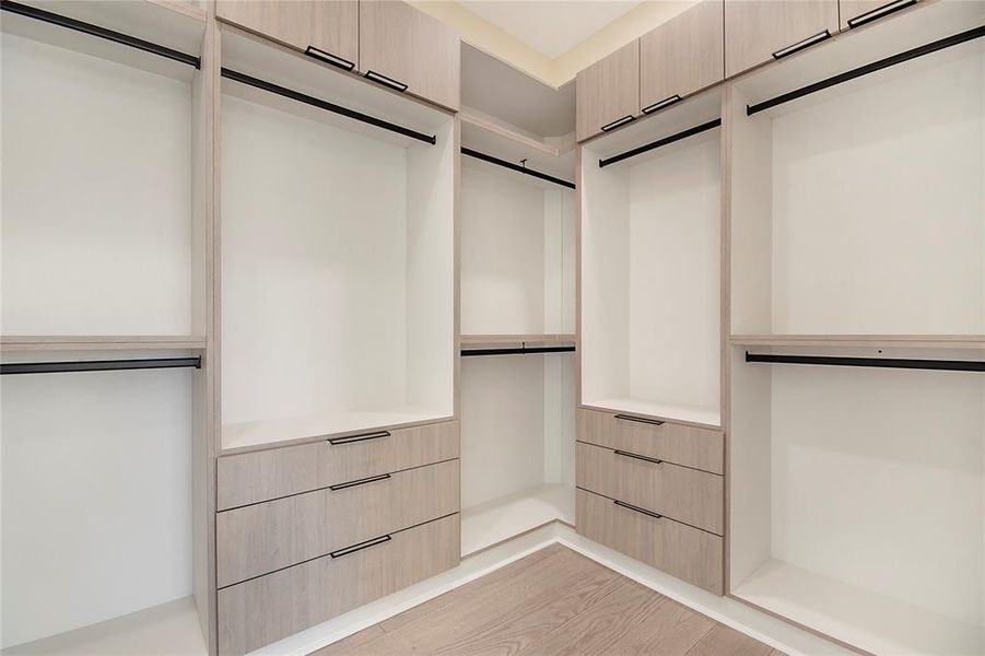 Spacious closet featuring light wood-style floors Spacious closet featuring light wood-style floors