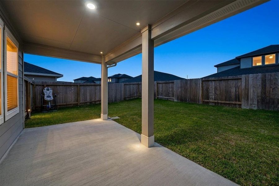 Enjoy outdoor living with a covered patio and a spacious backyard, perfect for hosting and relaxation       ***Twilight Enhanced Photo***